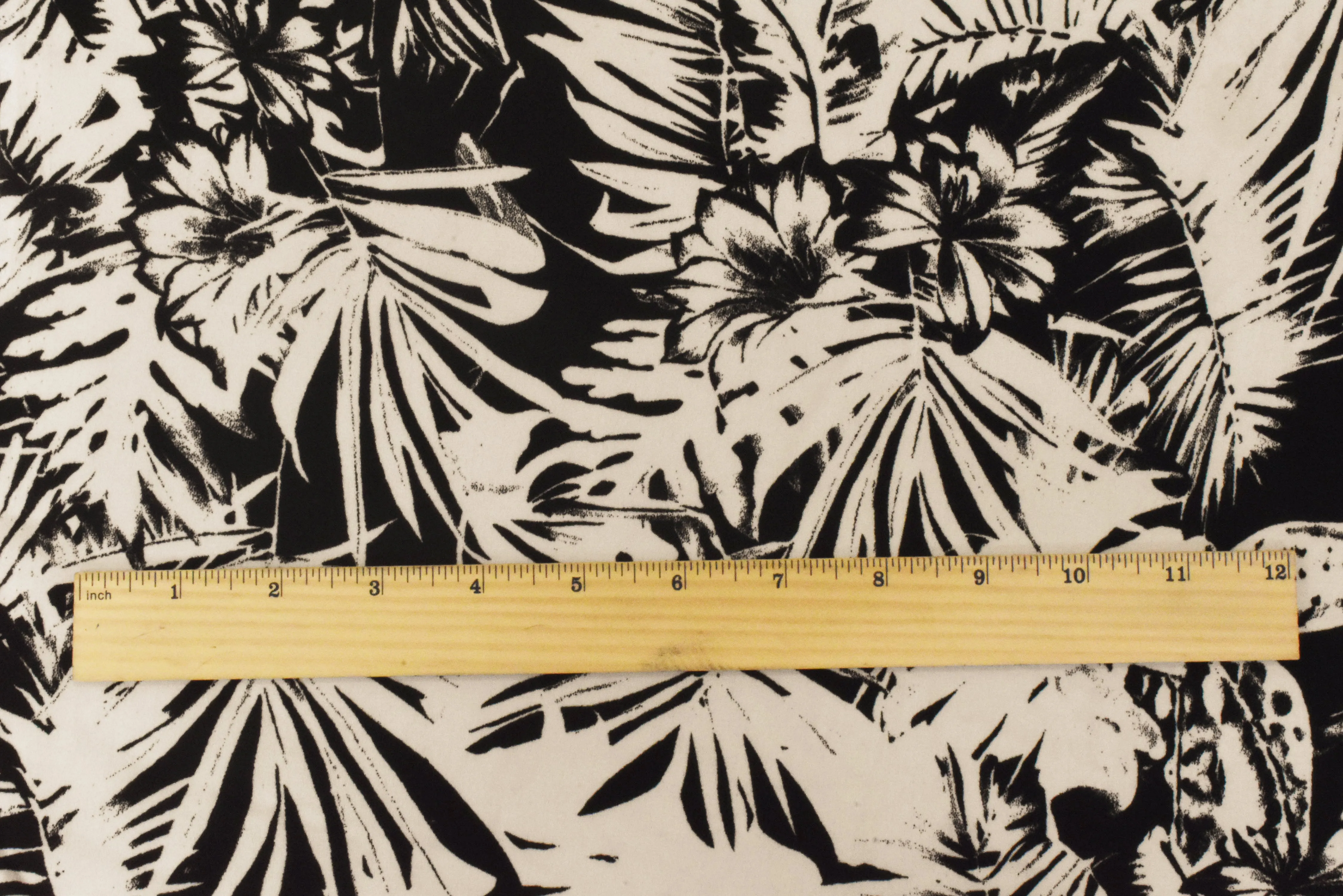 Ivory-Black Leaves Printed Poly Georgette Woven Fabric